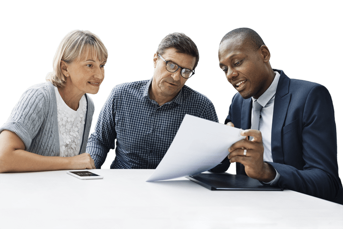 a salesman discussing paperwork with a middle-aged couple